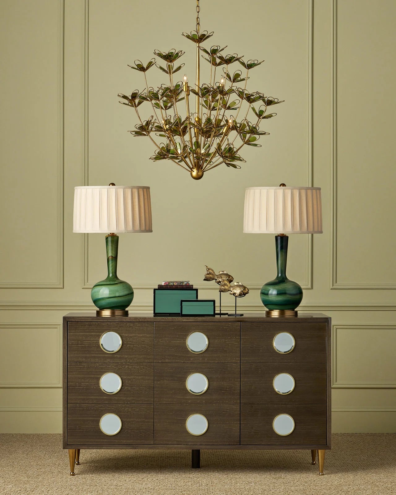 Elegant display of the Goldfish Set of 2 by Currey and Company on a modern dresser accompanied by a tall green lamp, showcasing how these sculptures can elevate a luxurious interior design.