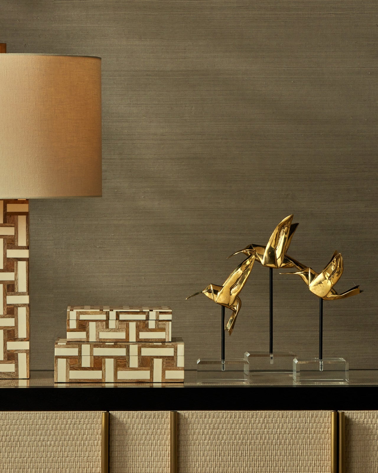 Full view of the Gold Hummingbirds Set of Sculptures by Currey and Company, highlighting the gold polish finish and acrylic bases.