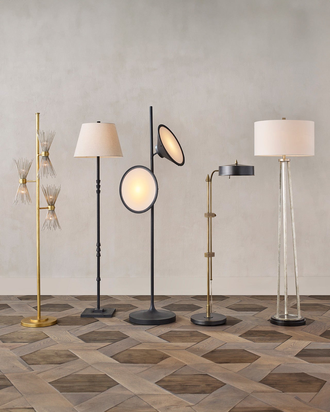 Novatude Gold Floor Lamp in a styled room with various modern floor lamps on a patterned wooden floor, illustrating its compatibility with contemporary interior designs.