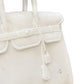 Close-up view of the intricate tag detailing on the Marble Sculpture of The Princess by Currey and Company, available at ChicHomeVibes.com. This image captures the exquisite craftsmanship of the white marble replica Hermes Birkin Bag, emphasizing its similarity to the iconic Hermes Birkin and showcasing its luxurious appeal, ideal for sophisticated home decor collectors.