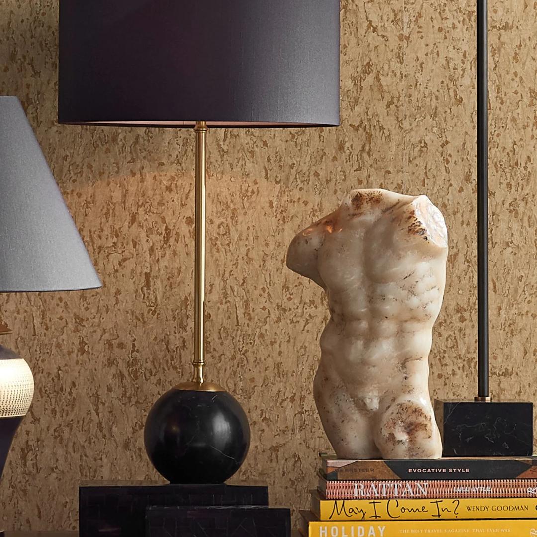Ancient Greek Torso by Currey & Company displayed on an accent table beside a modern lamp, blending classical and contemporary decor.