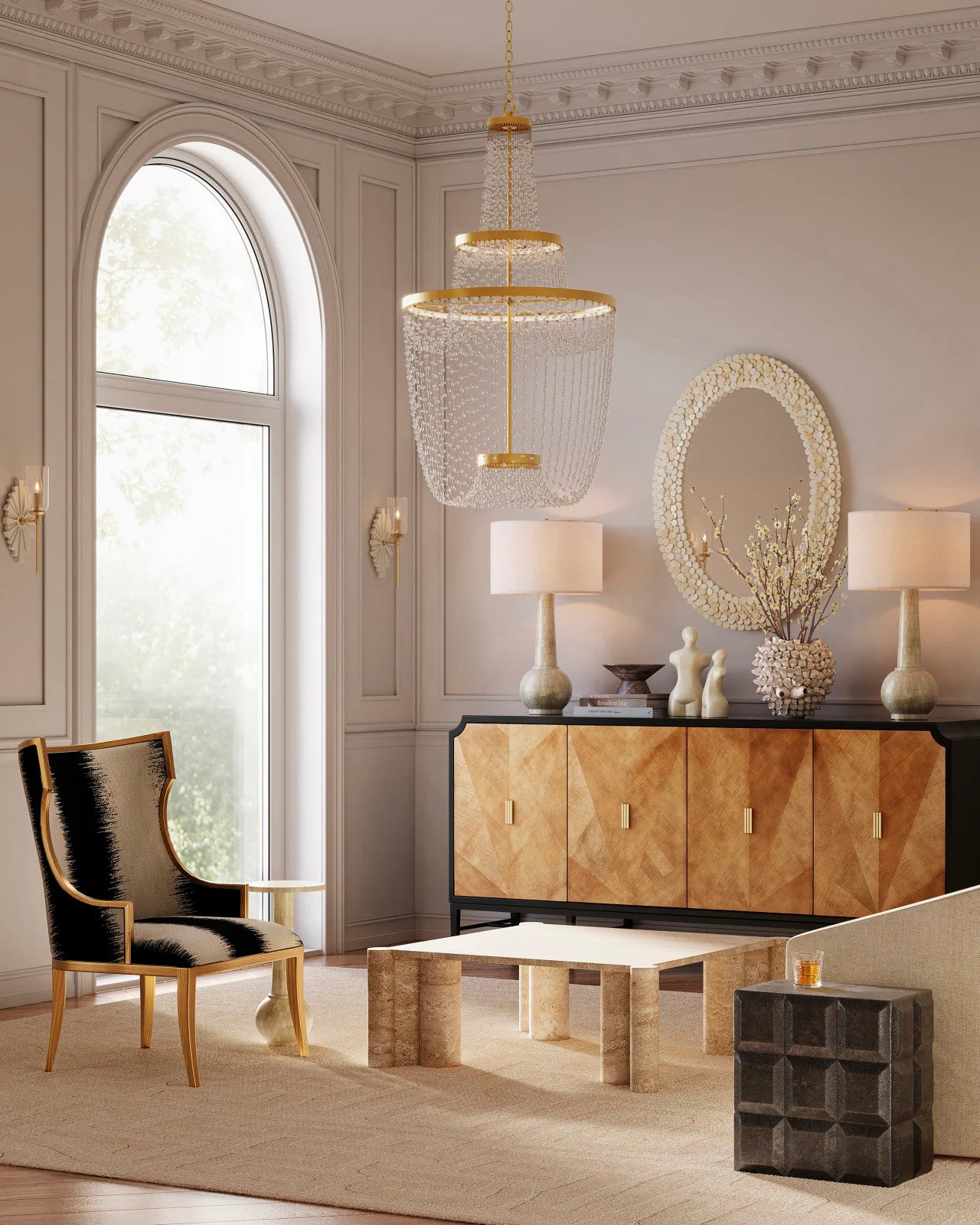 Elegant room showcasing the Mademoiselle Chandelier above a sculptural coffee table with arched windows and a glam accent chair.
